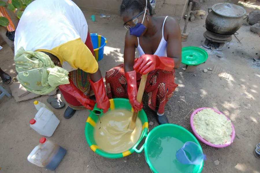 Two women making shea butter.